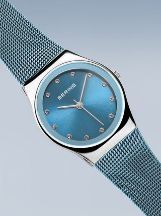 Angle shot of Bering 12927-308 Blue Stainless Steel Womens Watch on white background