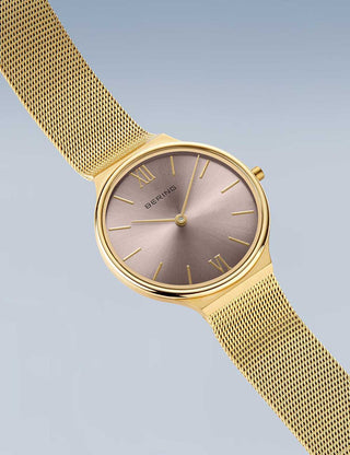 Angle shot of Bering 18434-336 Pink Dial Gold Stainless Steel Womens Watch on white background